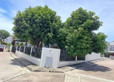 Corner view of a residential house surrounded by trees