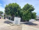 Corner view of a residential house surrounded by trees