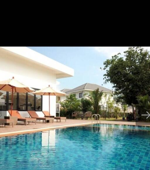 Swimming pool with lounge chairs and umbrellas