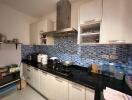 Modern kitchen with mosaic tile backsplash