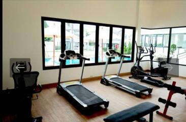 Fitness room with exercise equipment and large windows