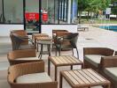 Outdoor seating area with wicker furniture and nearby pool