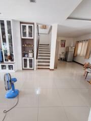 Bright and spacious main living area with stairs and modern decor