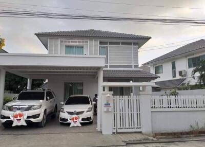 Modern two-story house with front yard and carport