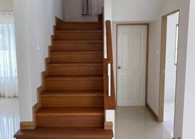 Wooden staircase in bright hallway