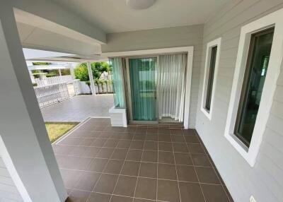 Cozy porch area with tiled floor and garden view