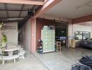 Spacious garage and seating area with storage cabinets, parked car, and outdoor furniture