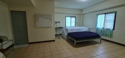 Spacious bedroom with tiled floor and double bed