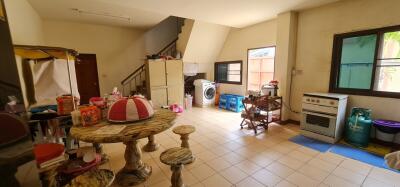 Cozy kitchen space with small dining area and laundry zone