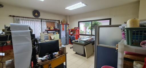 Spacious home office with various furnishings and equipment