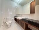 Modern bathroom with large mirror and wooden accents