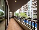 Spacious balcony with pool and building view