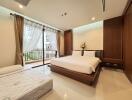 Spacious bedroom with a large window, double bed, and a single bed, featuring wooden furniture and modern decor