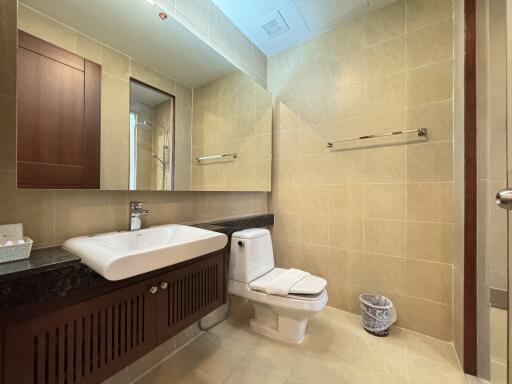 Modern bathroom with sink, mirror, and toilet