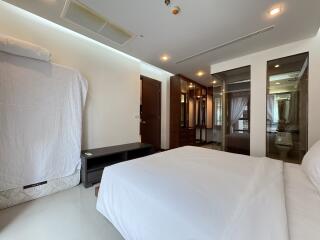 Spacious and modern bedroom with large bed and ample storage