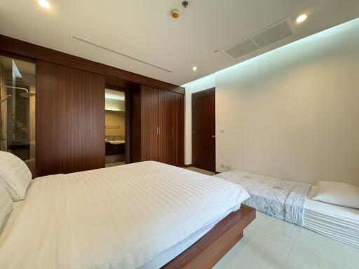 Modern bedroom with wooden accents and additional sleeping space