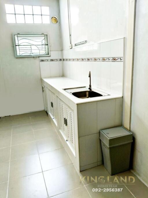 Simple kitchen with white cabinetry and tiled floor