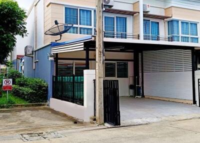 Front view of a two-story townhouse with a carport