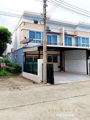 Front view of a two-story townhouse with a carport