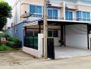 Front view of a two-story townhouse with a carport