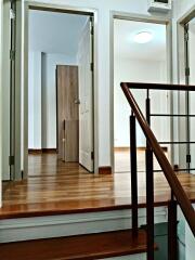 Bright hallway with wooden flooring and doorways