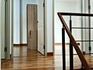 Bright hallway with wooden flooring and doorways