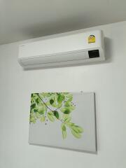 Bedroom with air conditioning and wall art