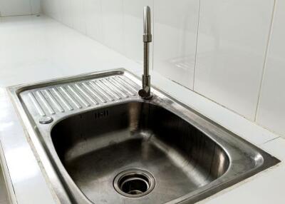 Modern kitchen sink with tile backsplash