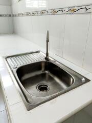 Modern kitchen sink with tile backsplash