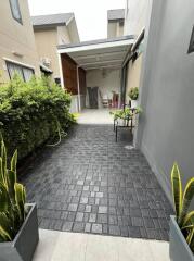 Paved outdoor entrance leading to covered area