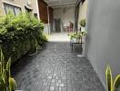 Paved outdoor entrance leading to covered area