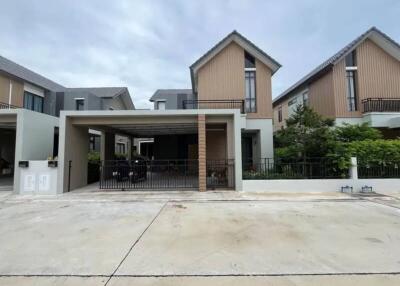 Modern residential building with a garage and patio area