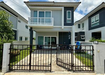 Front view of a contemporary two-story house with gated entrance