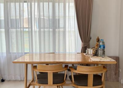 Modern dining area with wooden table and chairs