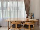 Modern dining area with wooden table and chairs