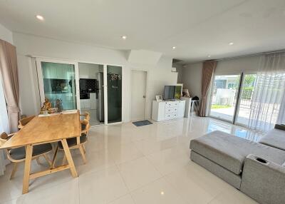 Modern living room with dining area and large windows