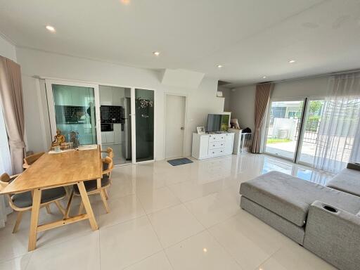 Modern living room with dining area and large windows