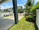 View of the front yard with driveway and gate