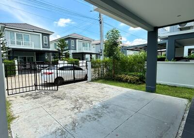 View of driveway leading to a modern house exterior