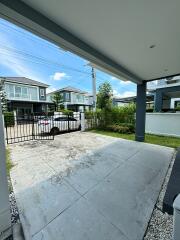 View of driveway leading to a modern house exterior