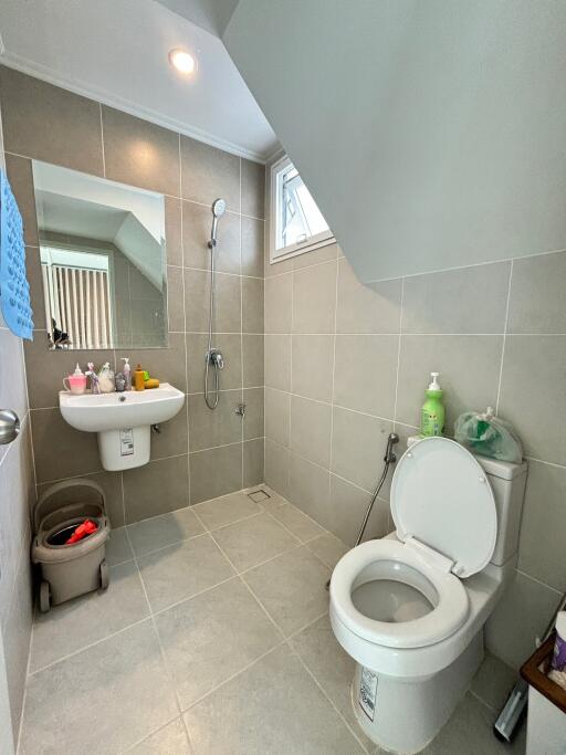 photo of a bathroom with a sink, toilet, and shower area