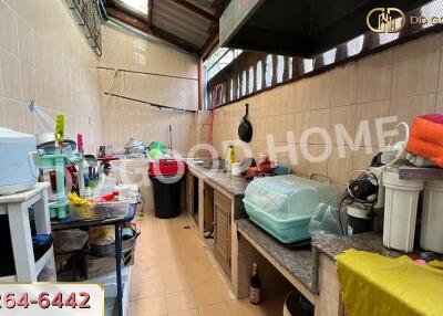 Spacious kitchen with various appliances and countertops