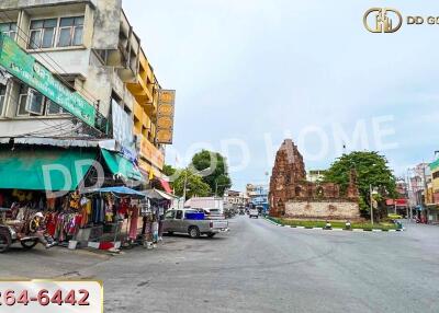 Street view with buildings and a historic monument