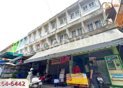 Exterior view of a commercial building with multiple floors and storefronts