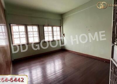 Spacious unfurnished living room with wooden flooring and large windows