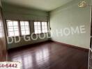 Spacious unfurnished living room with wooden flooring and large windows