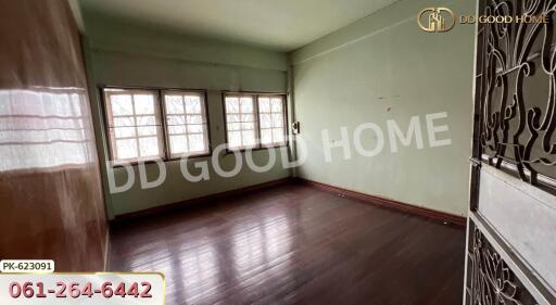 Spacious unfurnished living room with wooden flooring and large windows