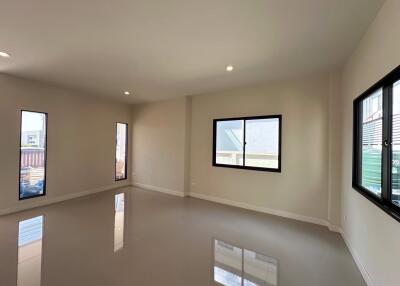 Spacious empty living room with large windows