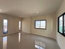 Spacious empty living room with large windows