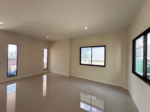 Spacious empty living room with large windows